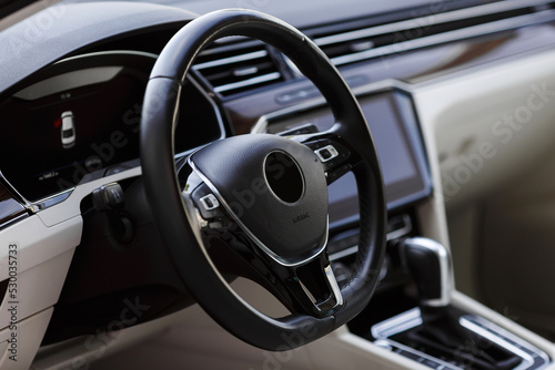 Steering wheel in a luxury modern car interior.