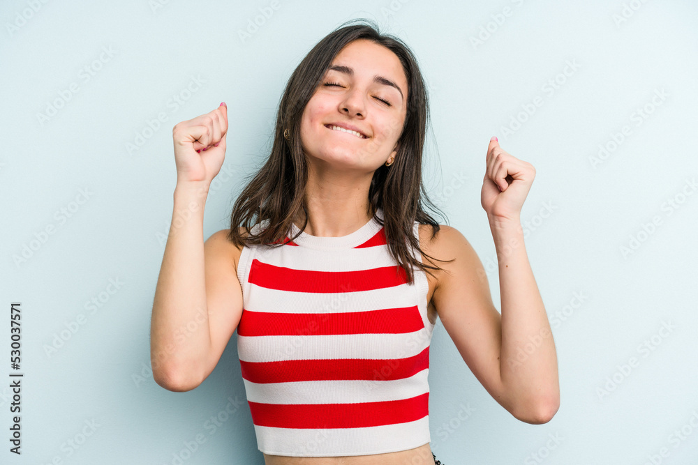 Young caucasian woman isolated on blue background celebrating a victory, passion and enthusiasm, happy expression. Young caucasian woman isolated on blue background celebrating a victory, passion and enthusiasm, happy expression.