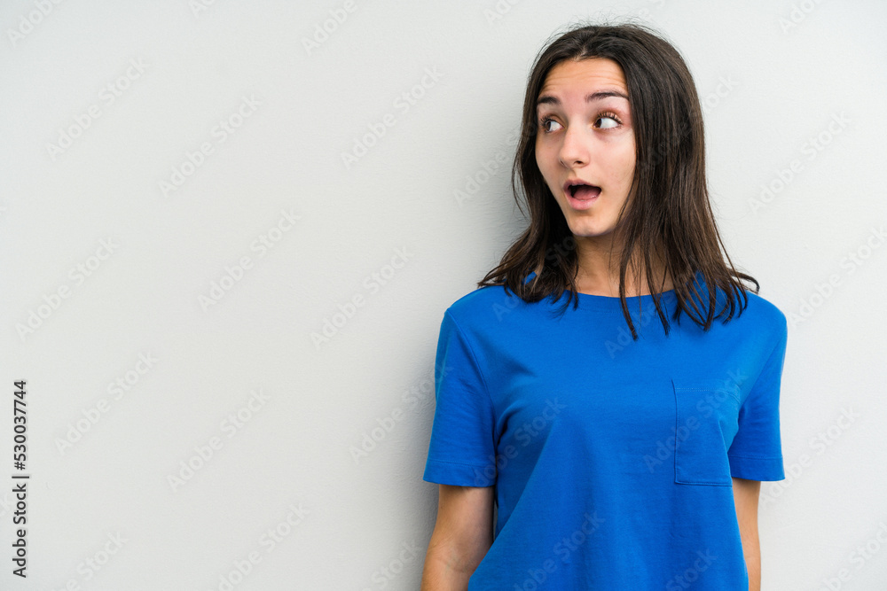 Young caucasian woman isolated on white background being shocked because of something she has seen. Young caucasian woman isolated on white background being shocked because of something she has seen.