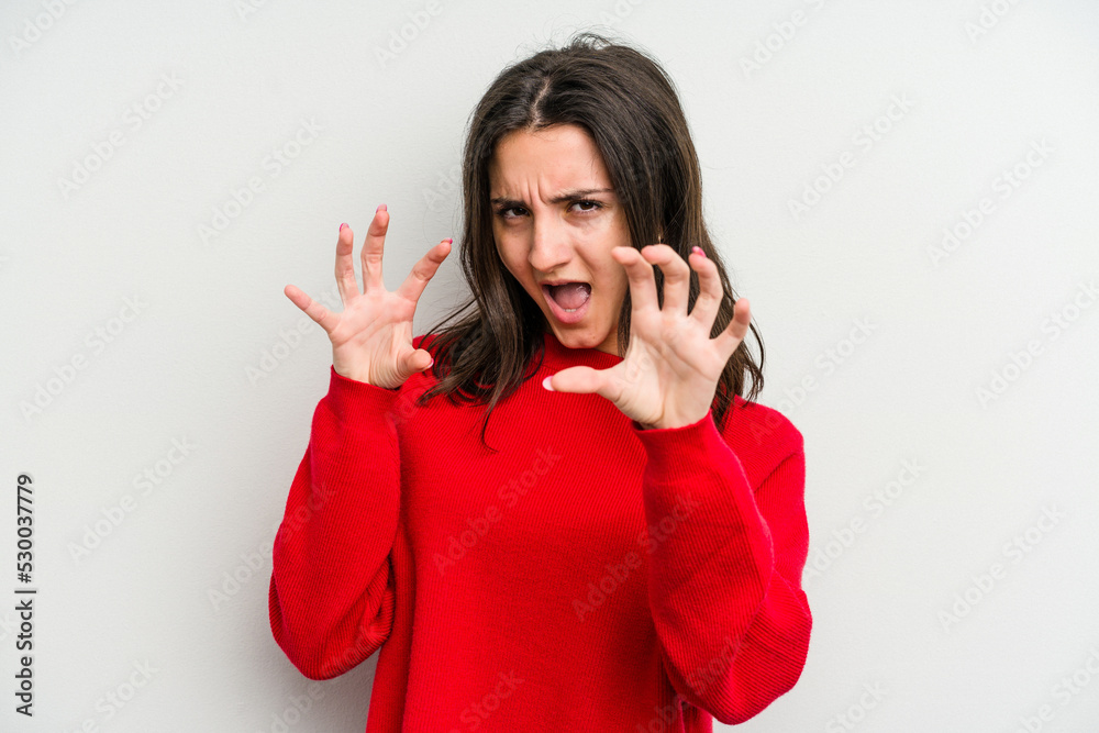 Young caucasian woman isolated on white background showing claws imitating a cat, aggressive gesture. Young caucasian woman isolated on white background showing claws imitating a cat, aggressive gesture.
