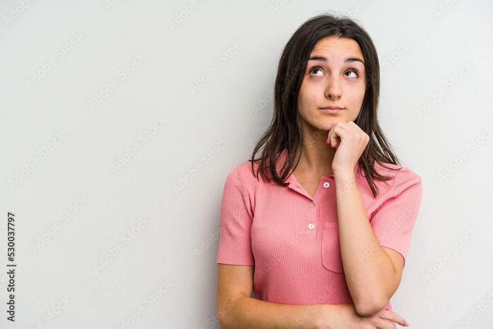 Young caucasian woman isolated on white background relaxed thinking about something looking at a copy space. Young caucasian woman isolated on white background relaxed thinking about something looking at a copy space.
