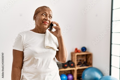 Senior african american woman smiling confident talking on the smartphone at sport center