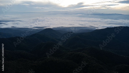 Aerial view of sea of fog on tropical mountains in the early morning.
