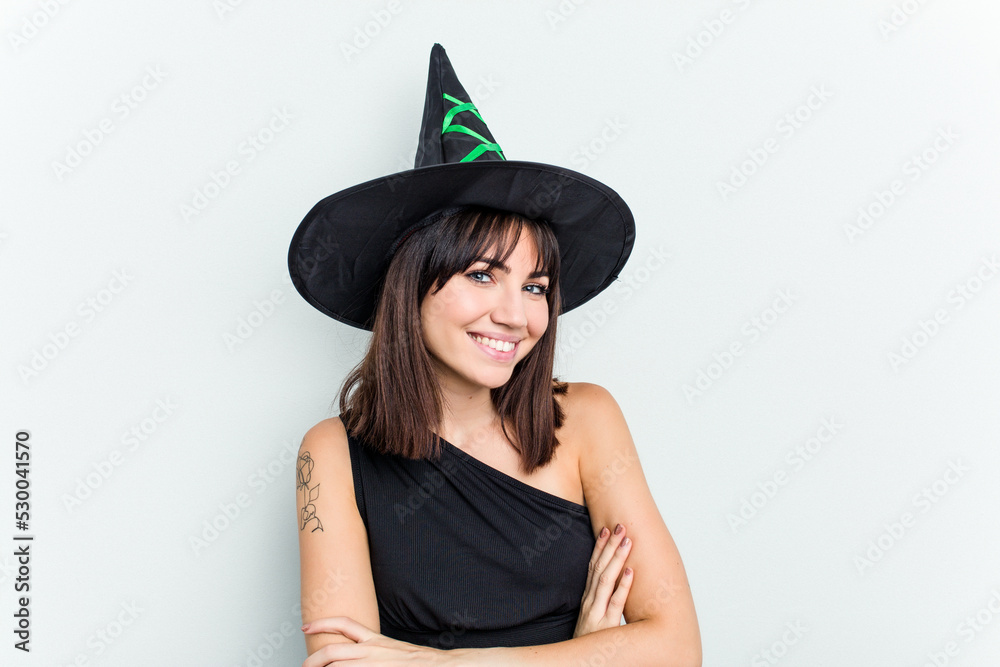 Young caucasian woman dressed as a witch isolated on white background laughing and having fun. Young caucasian woman dressed as a witch isolated on white background laughing and having fun.