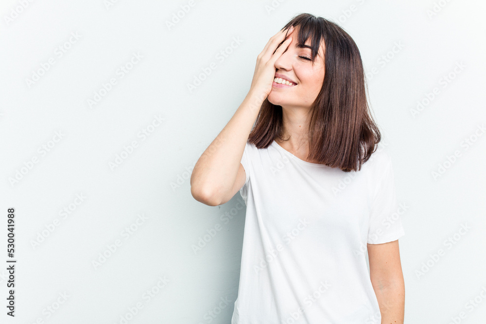 Young caucasian woman isolated on white background laughing happy, carefree, natural emotion.