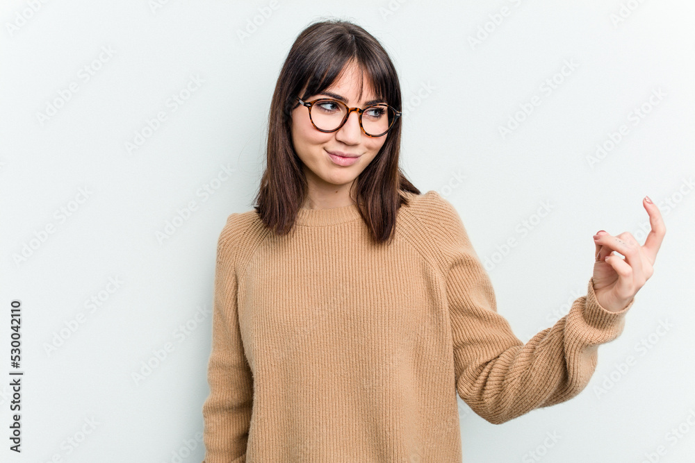 Young caucasian woman isolated on white background pointing with finger at you as if inviting come closer. Young caucasian woman isolated on white background pointing with finger at you as if inviting come closer.