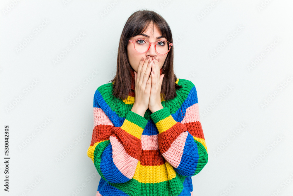 Young caucasian woman isolated on white background covering mouth with hands looking worried. Young caucasian woman isolated on white background covering mouth with hands looking worried.