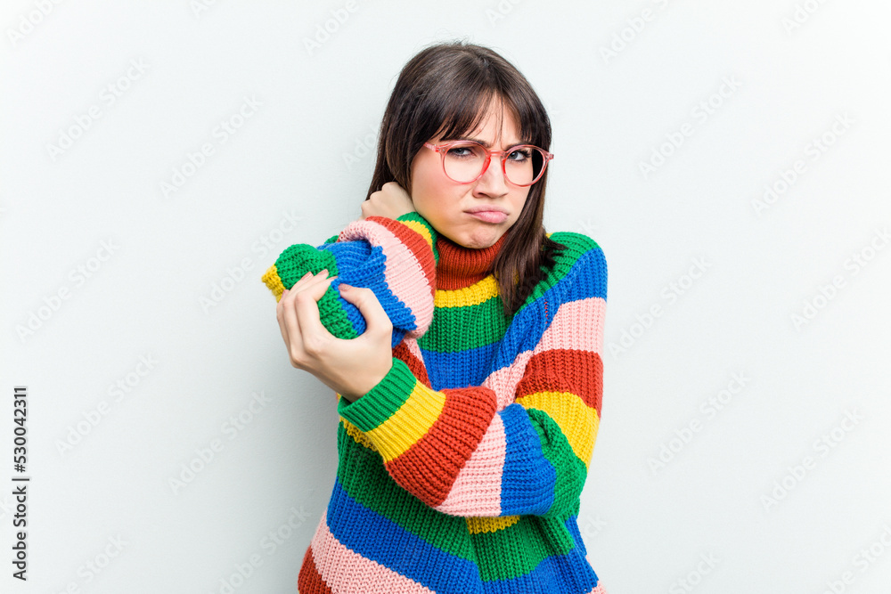 Young caucasian woman isolated on white background having a neck pain due to stress, massaging and touching it with hand. Young caucasian woman isolated on white background having a neck pain due to stress, massaging and touching it with hand.