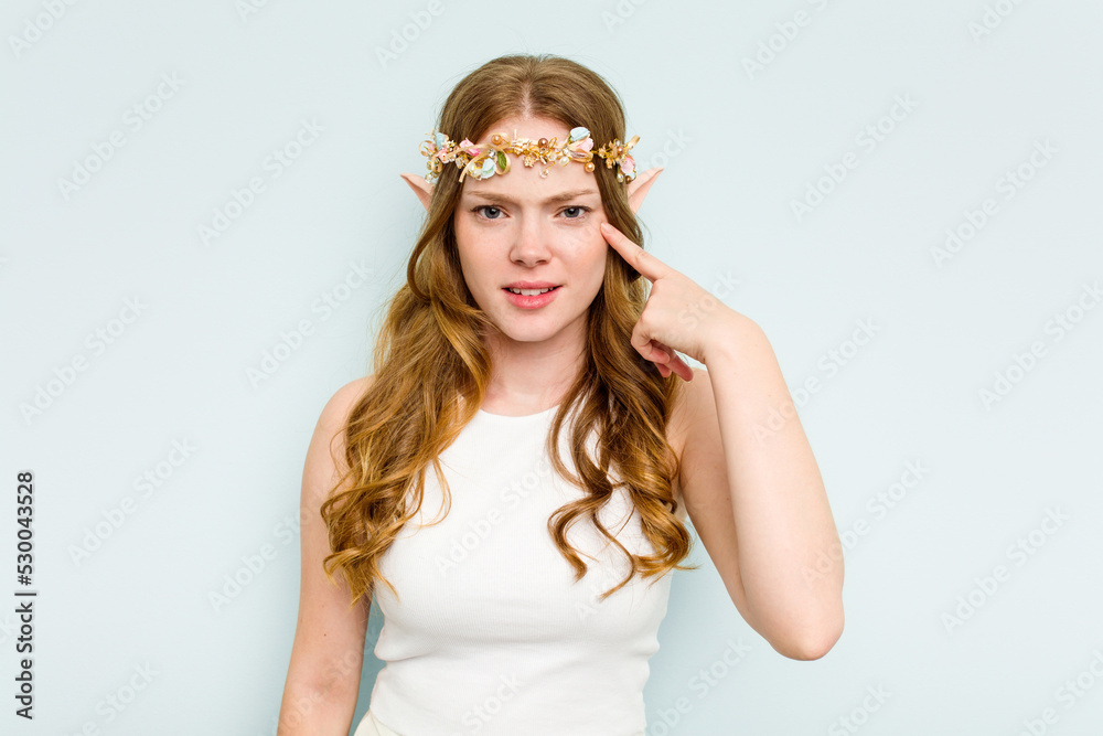 Young elf woman isolated on blue background showing a disappointment gesture with forefinger. Young elf woman isolated on blue background showing a disappointment gesture with forefinger.