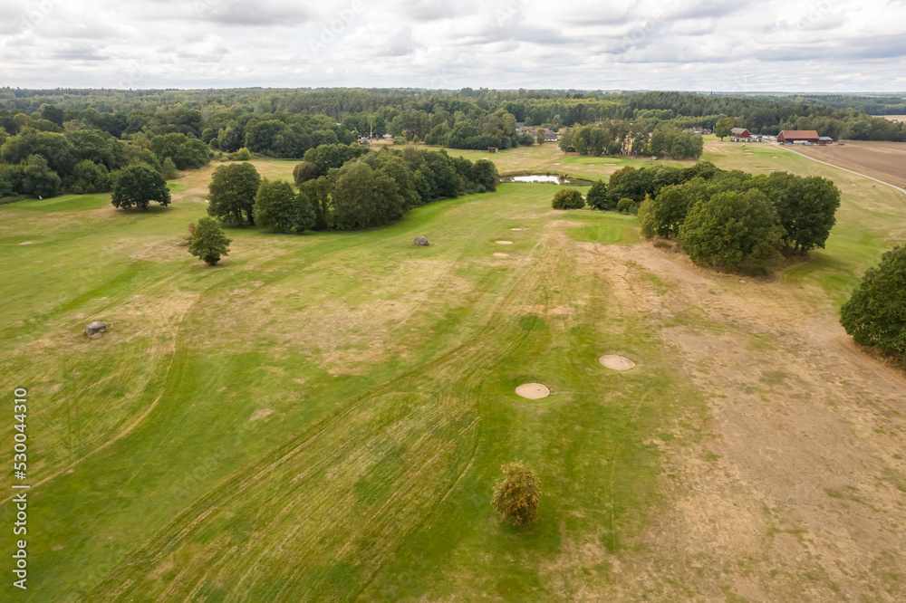 Sweden, Knislinge – September 10, 2022: Aerial view of a little village, golf course, green field Sweden, Knislinge – September 10, 2022: Aerial view of a little village, golf course, green field
