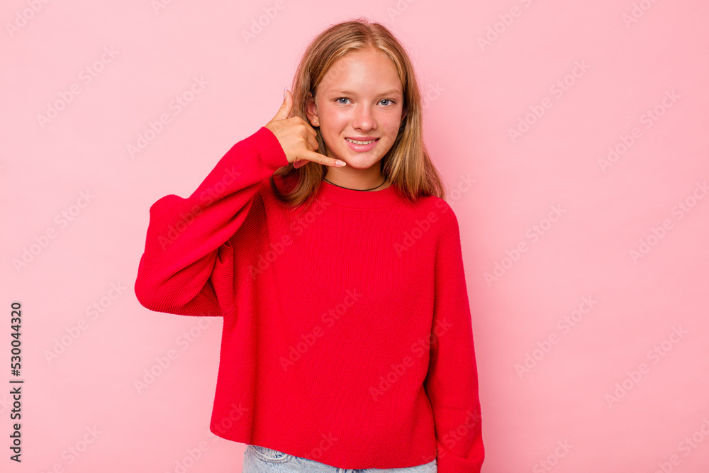 Caucasian teen girl isolated on pink background showing a mobile phone call gesture with fingers. Caucasian teen girl isolated on pink background showing a mobile phone call gesture with fingers.
