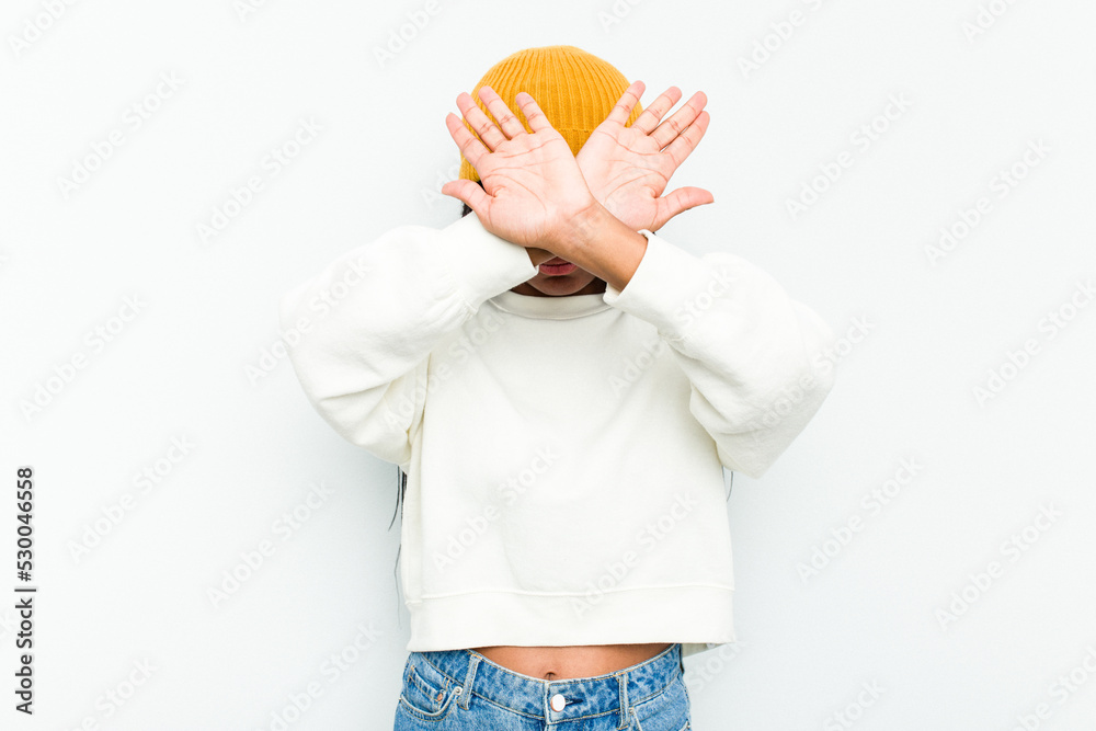 Young African American woman isolated on white background keeping two arms crossed, denial concept. Young African American woman isolated on white background keeping two arms crossed, denial concept.