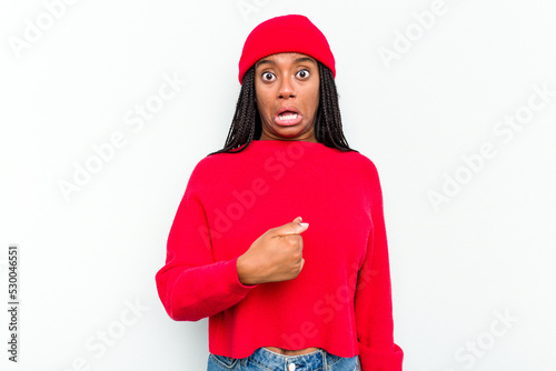 Young African American woman isolated on white background surprised pointing with finger, smiling broadly.