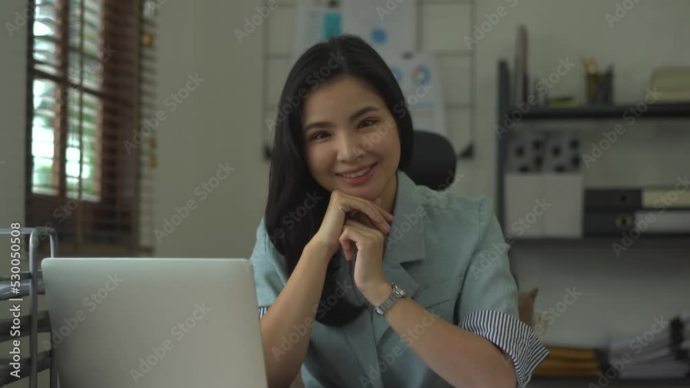 Young attractive asian business woman looking to camera and feeling happy. Young attractive asian business woman looking to camera and feeling happy.