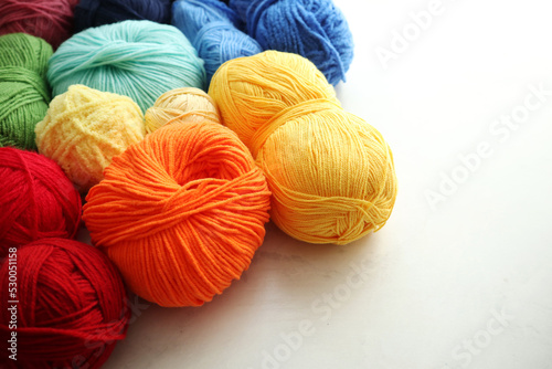 Composition with rainbow yarn balls on light background 