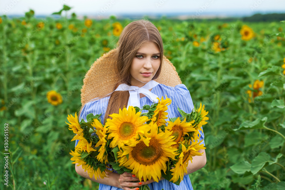 Young beautiful girl with a bouquet of sunflowers Young beautiful girl with a bouquet of sunflowers