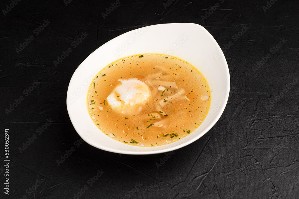 Chicken soup, chicken soup on a black background side view Chicken soup, chicken soup on a black background side view