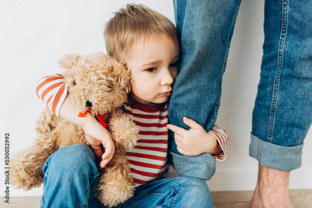 Caucasian little boy, hugging his father at home, isolated image, copy space. Family concept Caucasian little boy, hugging his father at home, isolated image, copy space. Family concept