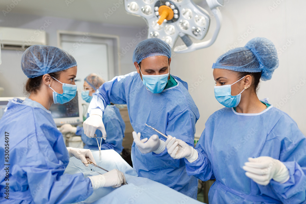 Shot in the Operating Room, Assistant Hands out Instruments to Surgeons During Operation. Surgeons Perform Operation. Professional Medical Doctors Performing Surgery. Shot in the Operating Room, Assistant Hands out Instruments to Surgeons During Operation. Surgeons Perform Operation. Professional Medical Doctors Performing Surgery.