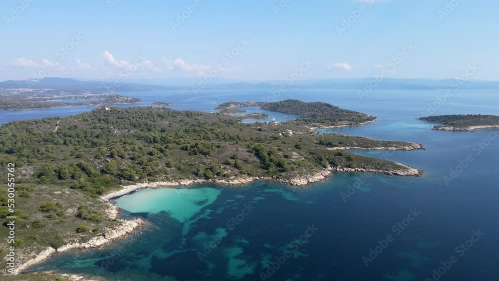 Ascending aerial view of Diaporos Island in Greece, Famous European holiday destination for travel Ascending aerial view of Diaporos Island in Greece, Famous European holiday destination for travel