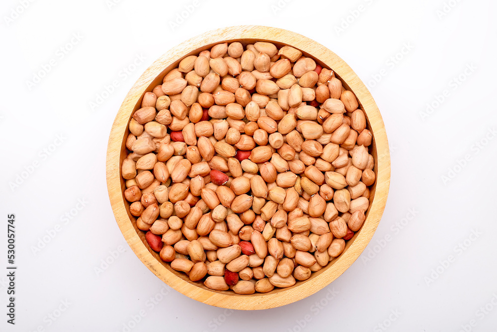 peanuts in a wooden bowl isolated on white background peanuts in a wooden bowl isolated on white background