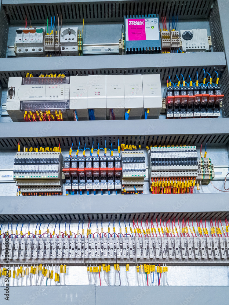 Mitsubishi PLC modules in a row in electrical cabinet of automation ...