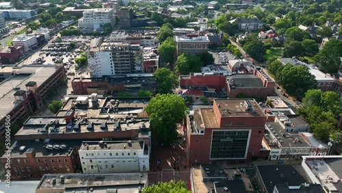 Aerial establishing shot of downtown Charlottesville Virginia. Buildings during summer evening golden hour. photo