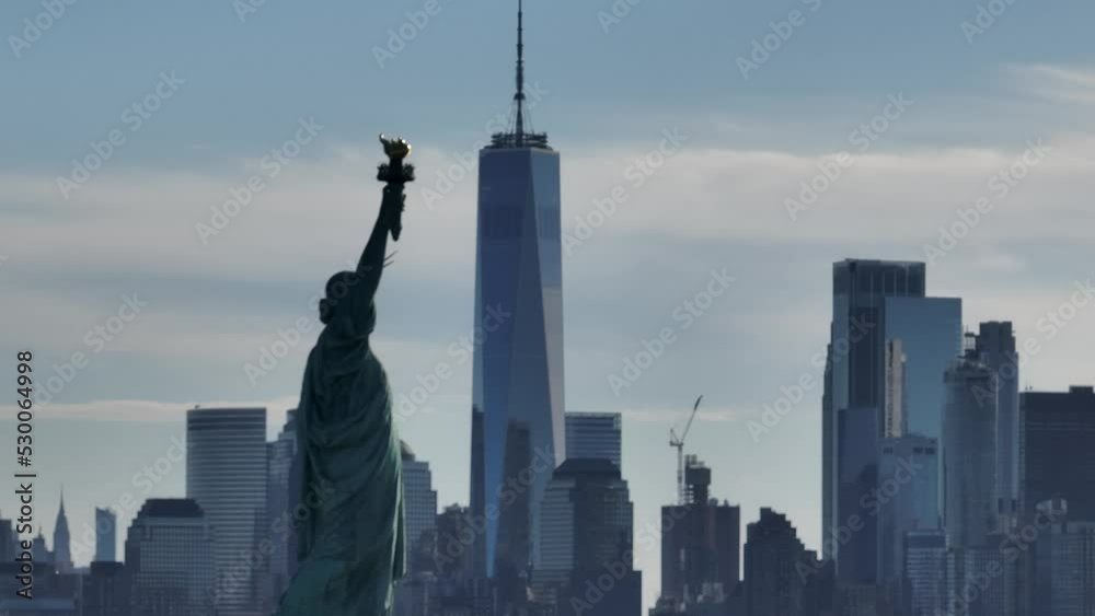 An aerial view of the Statue of Liberty with the freedom tower in the