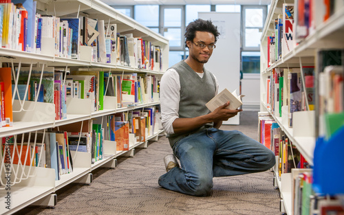 Teenage Students: In the Library. A male student making use of his college library. From a series of high school education related images.