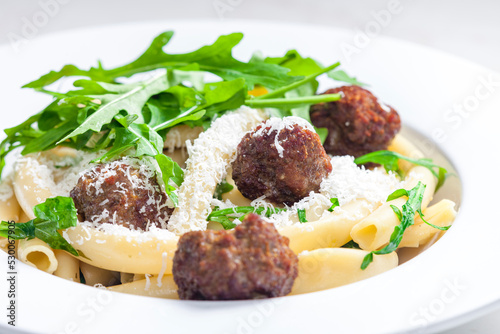 pasta macaroni with meat balls and arugula