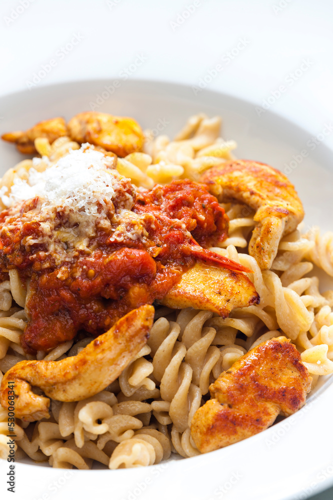 pasta fusilli with spicy chicken meat and tomato sauce