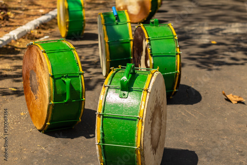 Detalhe de alguns tambores verdes guardados no chão, usados durante as Congadas, manifestação cultural e religiosa afro-brasileira. photo