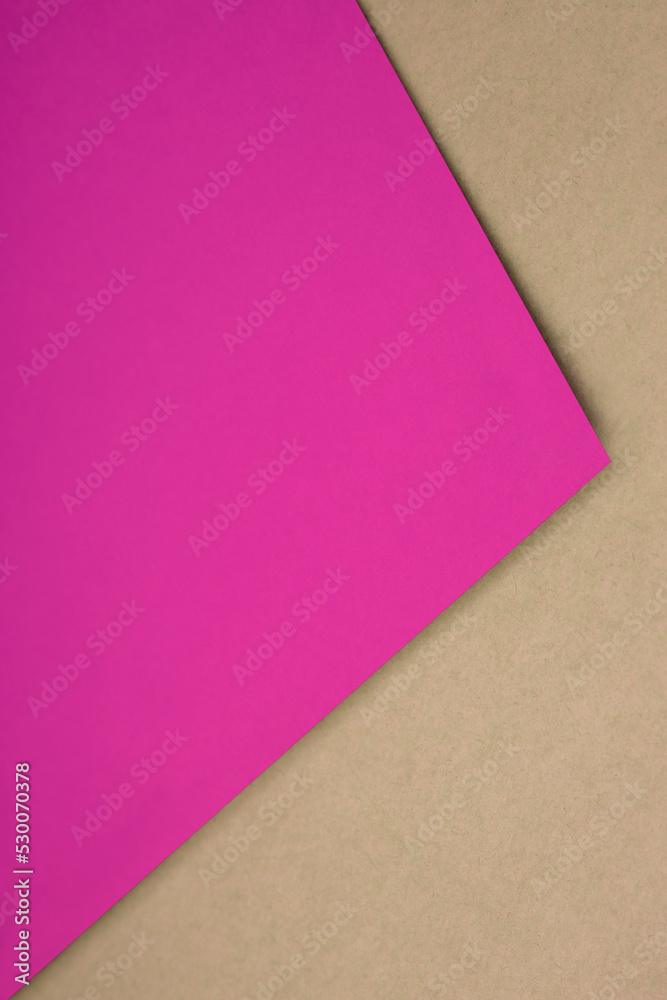 Plain pink paper sheet lying on yellow brown textured Background like an open book from top angle Plain pink paper sheet lying on yellow brown textured Background like an open book from top angle