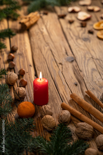 Traditional Czech Christmas on wood decoration with twig, candle, apple, orange, fruit