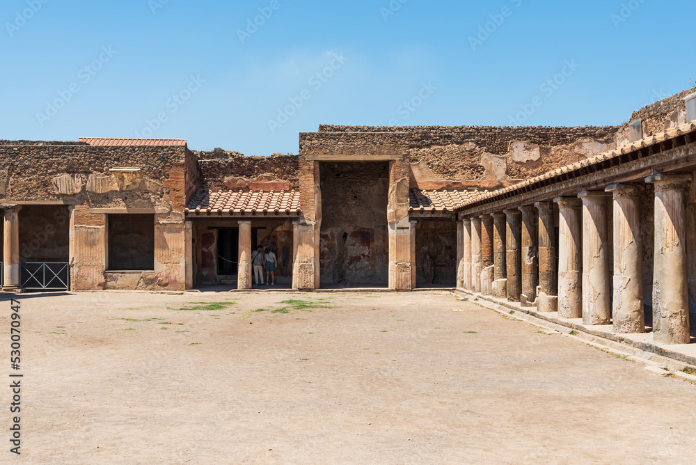 Patio in front of exterior facade of ancient roman house in Pompeii