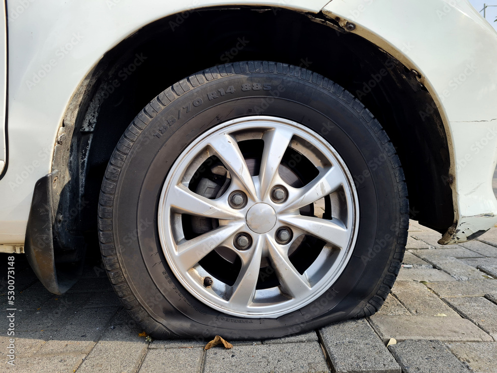 Close up car wheel flat tire on the road Close up car wheel flat tire on the road