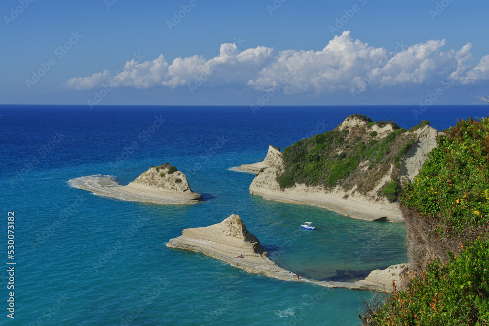 Kleines blau-weißes Boot in der Bucht von Kap Drastis, Korfu, Blick von oben, horizontal 