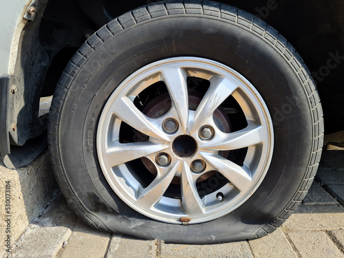 Close up car wheel flat tire on the road