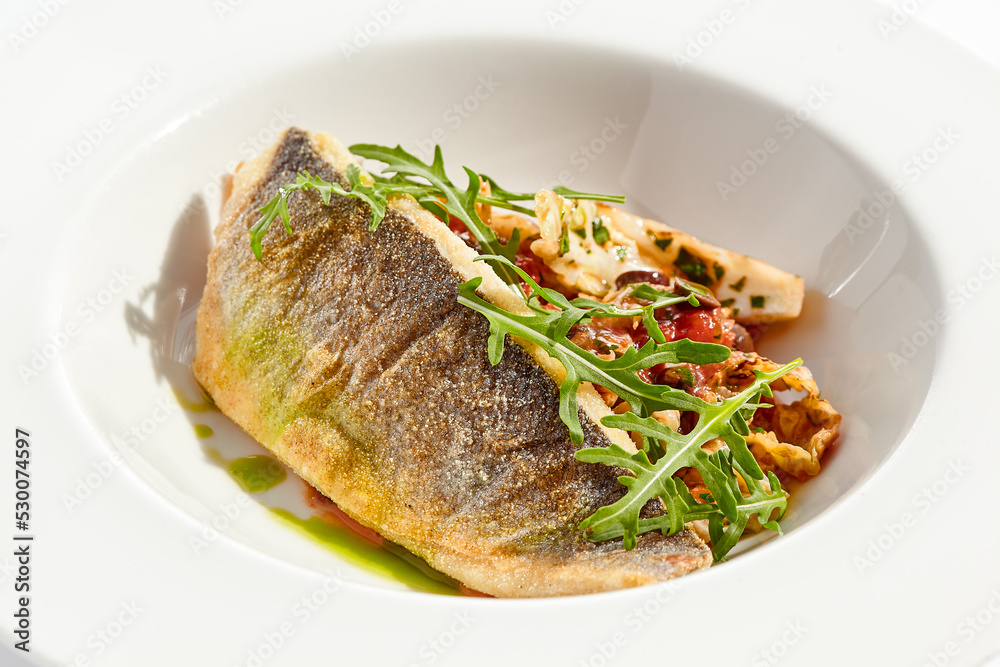Roast white fish with vegetables isolated on white background. Grill halibut with crispy skin and tomato salad. Fish fillet with vegetables garnish in minimal style. Seafood Restaurant menu. Roast white fish with vegetables isolated on white background. Grill halibut with crispy skin and tomato salad. Fish fillet with vegetables garnish in minimal style. Seafood Restaurant menu.