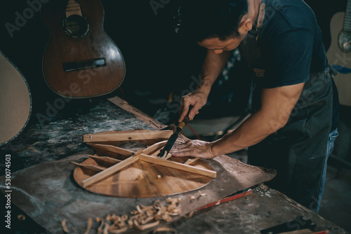Obraz na płótnie Guitar makers asian man making acoustic guitars in laboratory