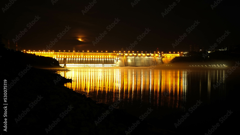 Divnogorsk, Russian Federation - July 11, 2022. Krasnoyarsk HPP (named after the 50th anniversary of the USSR) with night illumination