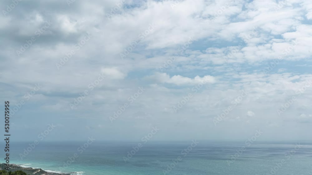 Cloudy sky and blue sea meet at the horizon by zooming out time lapse shot. Cloudy sky and blue sea meet at the horizon by zooming out time lapse shot.
