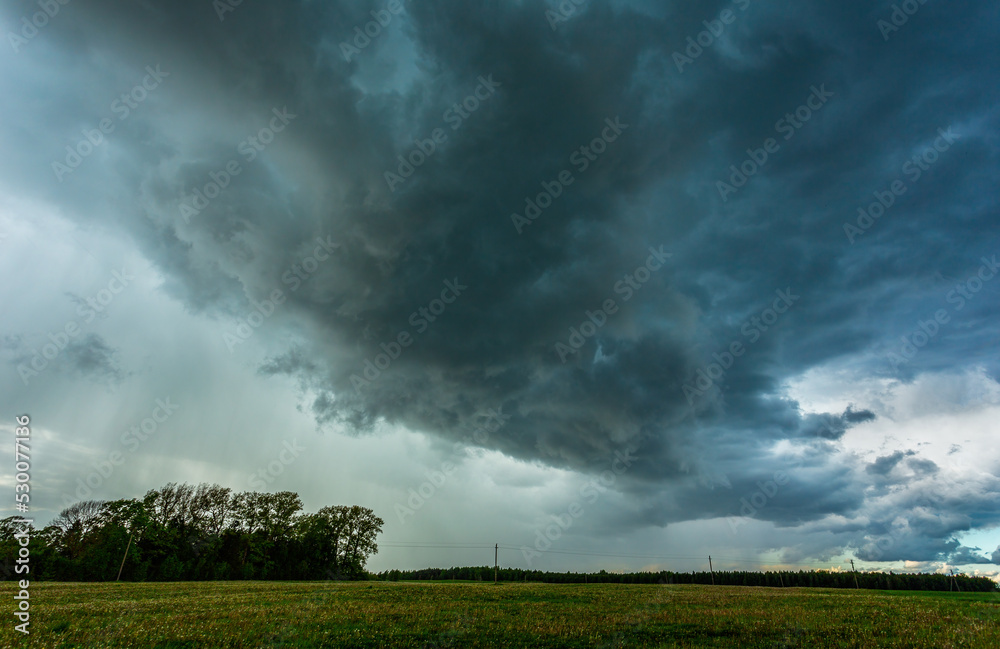 Storm clouds over field, tornadic supercell, extreme weather, dangerous storm Storm clouds over field, tornadic supercell, extreme weather, dangerous storm