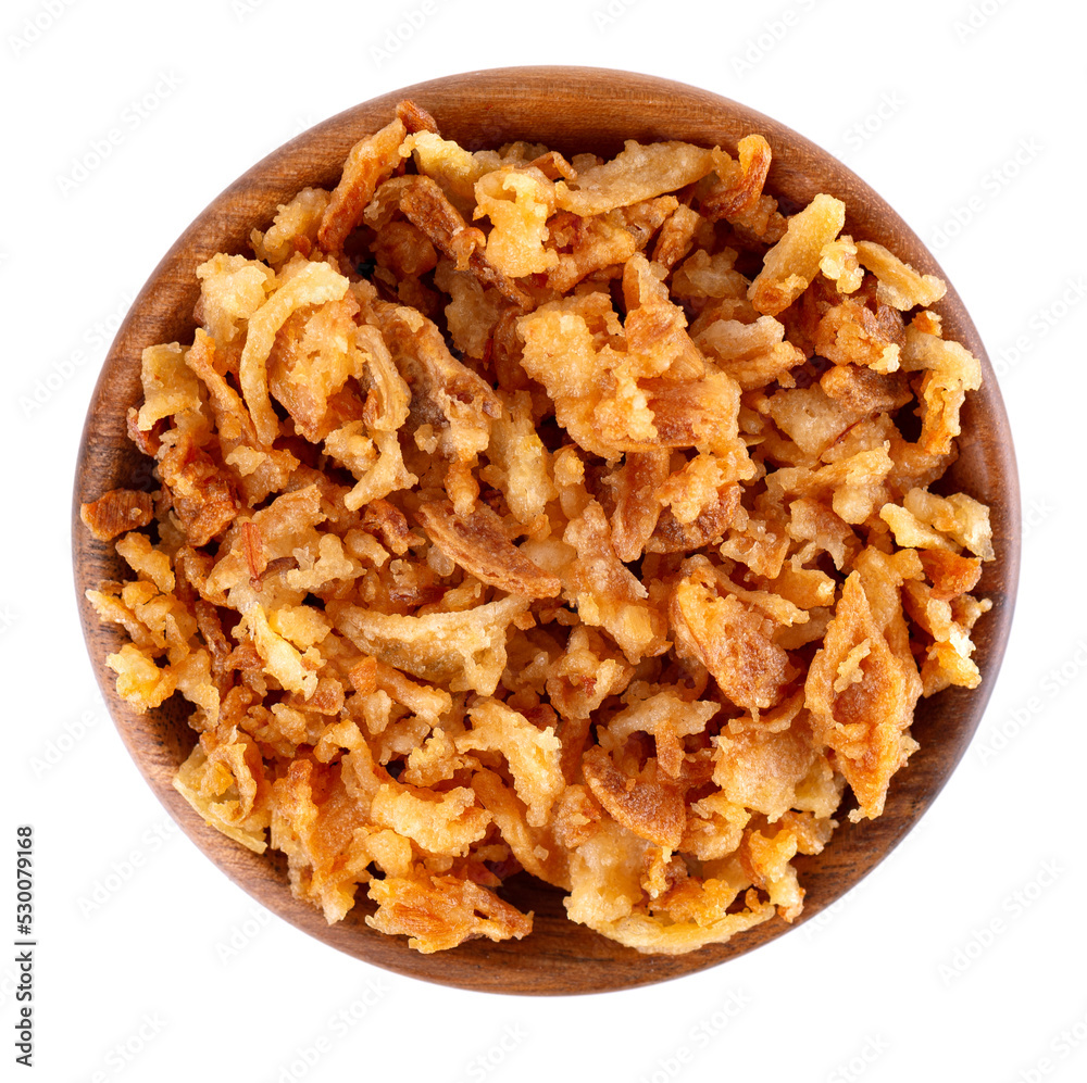 Roasted onions in wooden bowl, isolated on white background. Crispy fried onions. Top view. Roasted onions in wooden bowl, isolated on white background. Crispy fried onions. Top view.