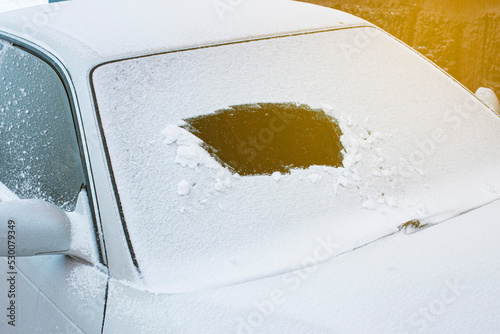 powdered car with the first snow, the problem of cleaning the windshield with wipers in the cold. Front and back background blurred with bokeh effect photo