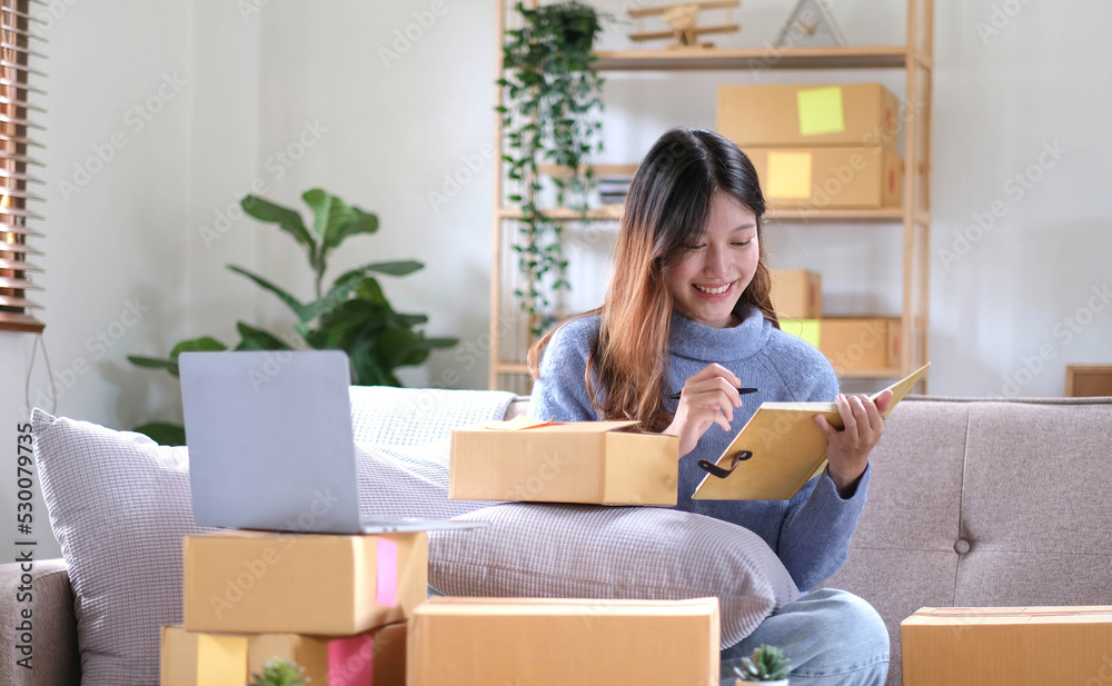 Startup small business owner working with computer at workplace. Freelance two woman seller check product order. Packing goods for delivery to customer. Online selling. E-commerce. Shipping concept Startup small business owner working with computer at workplace. Freelance two woman seller check product order. Packing goods for delivery to customer. Online selling. E-commerce. Shipping concept