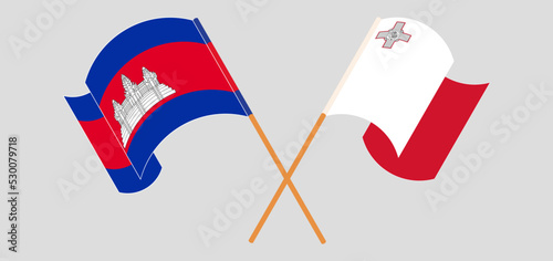 Crossed and waving flags of Cambodia and Malta