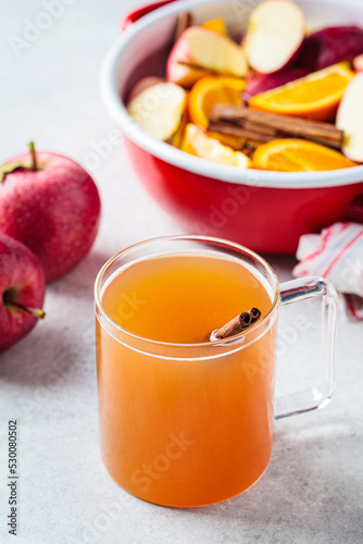 Homemade hot apple cider in glass cup. Autumn or winter warming drink.