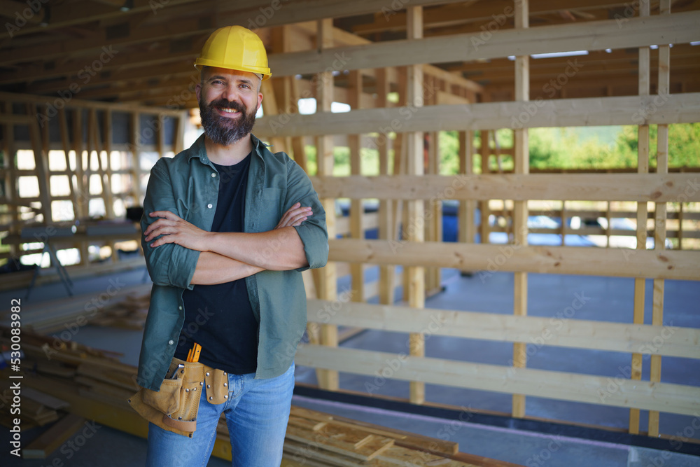 Portrait of construction worker smiling and looking at camera, diy eco-friendly homes concept. Portrait of construction worker smiling and looking at camera, diy eco-friendly homes concept.