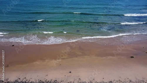 ocean waves line and sand meeting in the middle walking through drone footage 2.7k